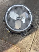 Front view of the Hunter floor fan showing the metal mesh guard and 3 blades with a Hunter logo badge on the grille.