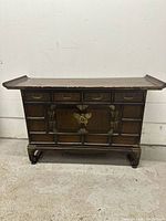 Front view of entire Korean wooden chest showing drawers, cabinet door, metal fixtures, and scroll feet.