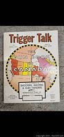 Front cover of 'Trigger Talk The Gun Book Canada' with colorful map and text.
