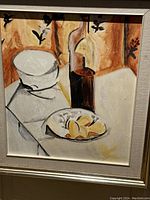 Frontal close-up image showing full painting with bottle, lemons on plate, and white covered dish against abstract background and floral silhouettes.