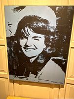 Frontal view of a large 20 x 28 inch portrait board print showing the black and deep electric blue stylized image of Jacqueline Kennedy Onassis.