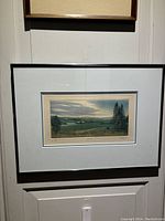 Framed print titled 'Quietude' showing Canadian farm landscape with matting and black frame