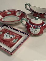 Overview of all four ceramic dishware items showing sugar bowl, gravy boat, serving dish, and rectangular tray with hand painted chicken designs