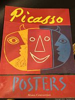 Front cover showing the title 'Picasso Posters' in bold yellow and blue text with abstract Picasso style faces in red, yellow, and blue on a red background.