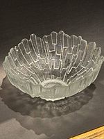 Top and angled view of the clear Murano glass fruit bowl, showing the Brutalist design and textured surface.