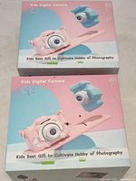 Two boxed kids digital cameras with packaging showing product images and branding