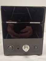 Front view of the watch winder showing control knob, power switches, and DC input.