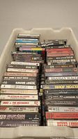 Photo of bin filled with cassette tapes showing spines with artist names and titles such as Bob Seger, Shania Twain, Tina Turner, Randy Travis, Elvis Presley, and others.