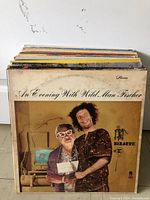 Front view showing 'An Evening With Wild Man Fischer' vinyl record cover featuring two people posing with an old computer in the background.