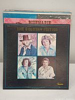 Front cover of The Country Edition vinyl album signed by all four band members.