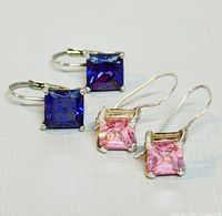 Two pairs of square cut gemstone earrings; one pair purple stones, one pair pink stones, set in 925 silver, arranged side by side.