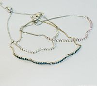 Three Pandora silver bracelets with stone inlays and adjustable sliding chain clasps shown together on a white surface