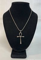 Front view of the necklace featuring the silver Ankh pendant displayed on a black mannequin bust, showing full length chain and pendant size.
