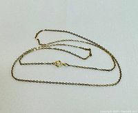 Yellow gold chain necklace laid flat showing overall condition and length.