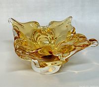 Angled side view showing amber color and organic folded shape