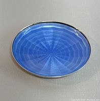 Top view of small oval dish showing blue guilloche enamel interior and sterling silver rim.