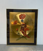 Full view of framed hand painted foil artwork showing figure, mushroom, flowers, and butterfly on gold foil background.