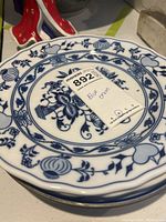 Blue Onion warming plate with traditional blue floral pattern and a lot tag on top