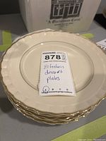 Stack of six ivory Elfenbein dessert plates with scalloped edges and gold trim, showing lot tag on top plate