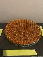 Stack of four orange amber textured glass plates with iridescent hints, round, about 8.5 inches diameter