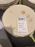 Showing stack of Heinrich dessert plates with floral design and gold trim