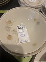 Two beige cream colored Heinrich serving bowls with leaf designs inside, labeled with lot 855 tag.