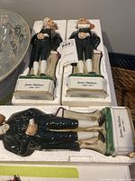 Three James Madison ceramic decanters shown in original foam packaging, detail of full figure and inscription on base as well as cork stopper head