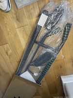 Bodyrox pull-up bar wrapped in bubble wrap showing black metal frame and padded grips.