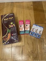 Photo of full lot including hair dye shampoo sachet, two boxed tubes of dark spot cream, and three boxed packs of Botox serum.
