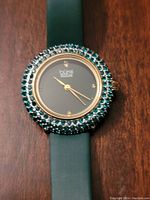 Close-up of the watch face showing Swarovski crystals and diamond markers.