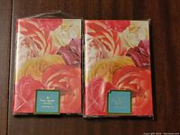 Two Kate Spade floral notebooks still in original packaging, showing colorful floral design on the cover.