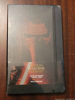 Front view of sealed notebook showing Kylo Ren embossed cover and Moleskine branding with Star Wars The Force Awakens label.