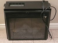 Front view of black Twinstar electric fireplace insert showing glass front panel and metal frame.