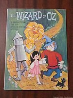 Front cover featuring Tin Man, Lion, Dorothy, Scarecrow, and Toto from The Wizard of Oz in colorful illustration