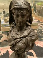 Front view of bust showing head, shoulders and drapery