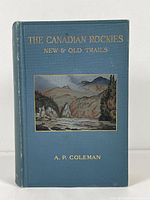 Front cover of the blue hardcover book showing the gilt title with a pressed color illustration of a mountain landscape.