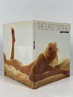 Angled view of 'The Last Sitting' book with cover image of nude Marilyn Monroe reclining on a bed.