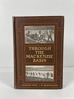 Front cover of the book 'Through the Mackenzie Basin' showing title, author names, and two photographs