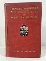 Front cover of the hardcover book showing title in gilt letters and color coat of arms on red cloth binding.