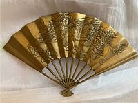Front view showing embossed horses and flowing mane detailed brass fan