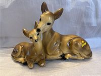 Front angle view of ceramic deer and fawn sculpture showing detail and markings.