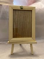 Front view of wooden picture frame showing glass and wood finish.