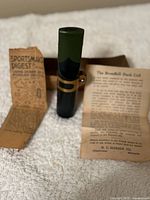 Broadbill Duck Call with original papers including Sportsman's Digest flyer and product description.