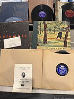 Multiple Columbia Records vinyl albums, including classical music by Brahms, Mozart, and Beethoven with paper sleeves and album covers visible showing composer and symphony names