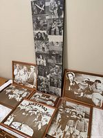 Five framed black-and-white photos featuring the Three Stooges, arranged on a flat surface against a wall.