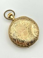 Closed hunter case front showing ornate floral and geometric engraving