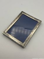 Front view of the Birks sterling silver rectangular photo frame showing tarnished surface and simple design.