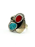 Front and angled view of Navajo style ring showing turquoise and red coral cabochons with decorative silver setting.