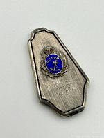 Front view of the sterling silver locket showing the blue enamel RCNVR badge with anchor and crown and monogrammed initials F.B.