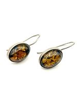 Close-up of both earrings showcasing amber cabochons and silver bezels.